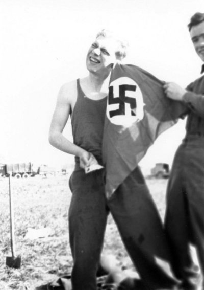 Two unidentified US  soldiers playing with a Nazi flag. .jpg